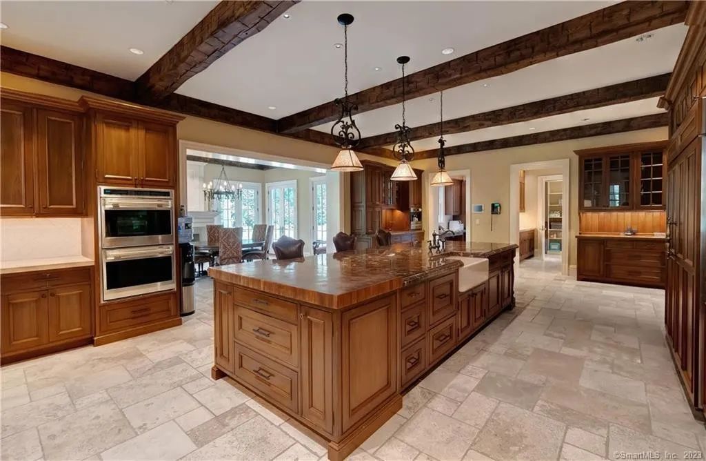 Custom kitchen with wood cabinetry and a large central island