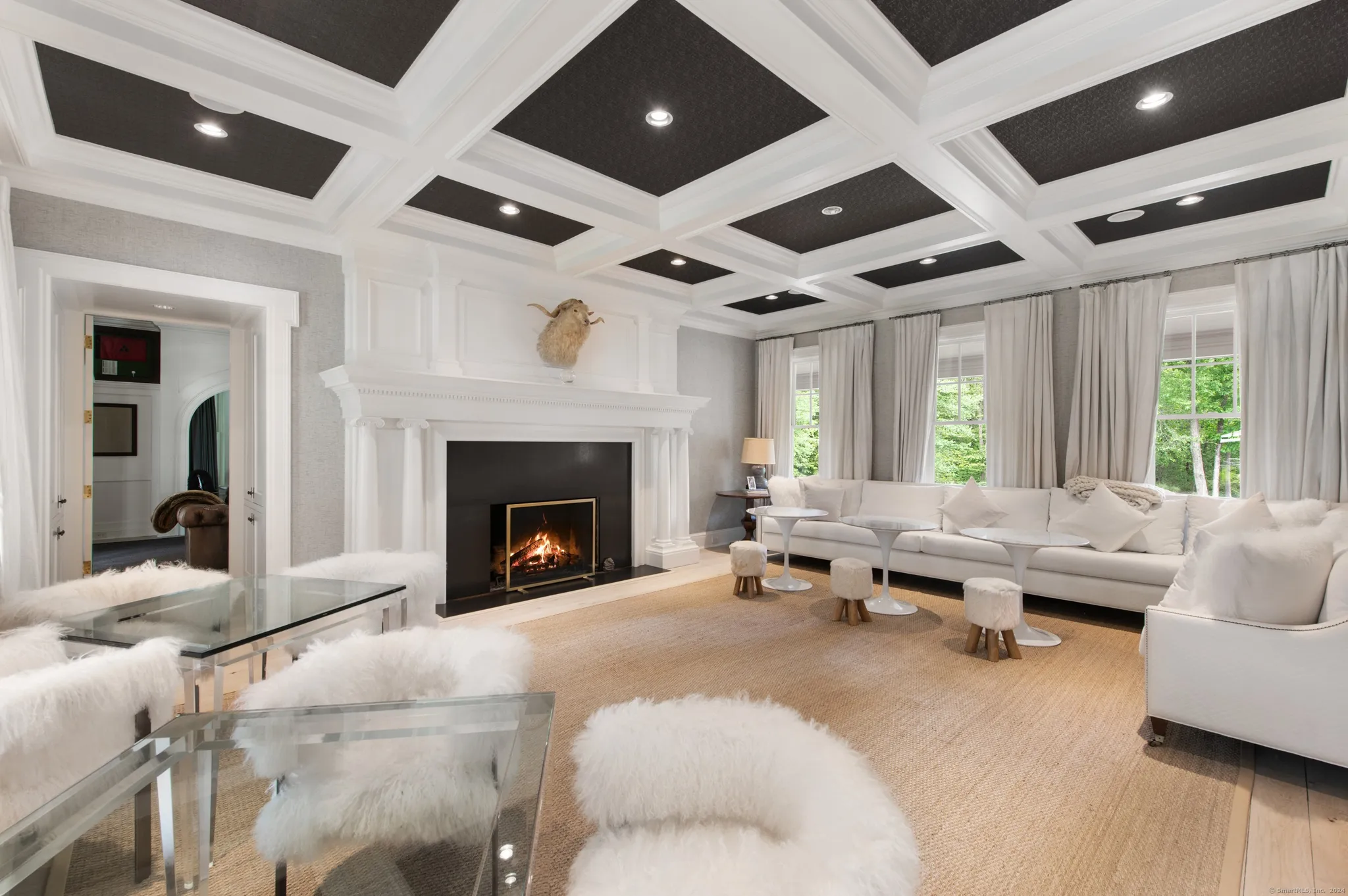 Bright great room with a coffered ceiling and a fireplace