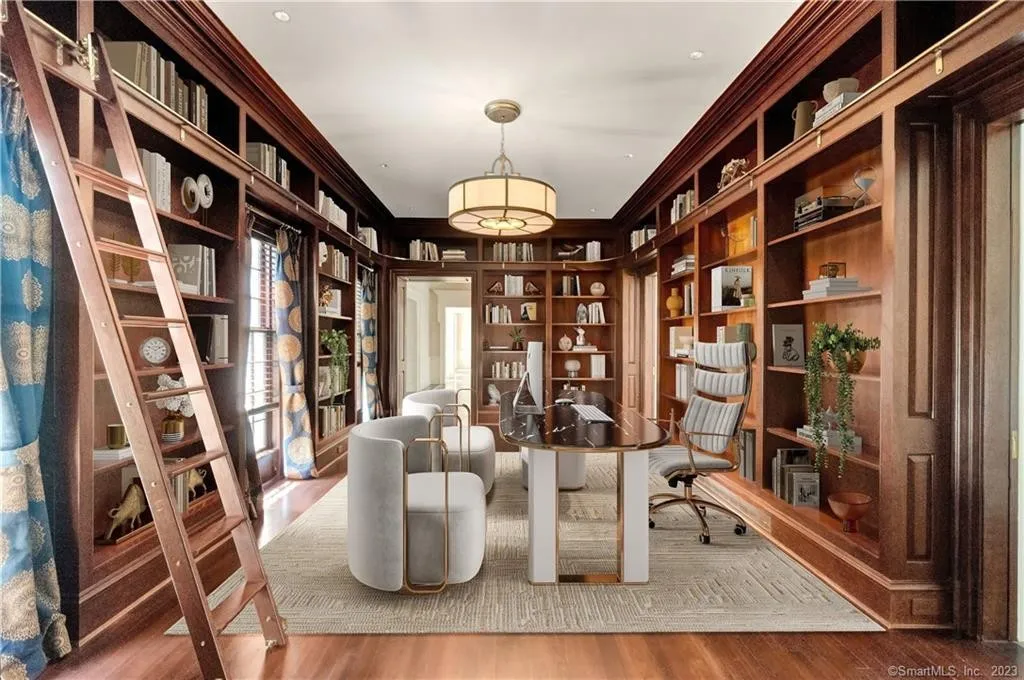 Traditional home library with built-in wood shelving