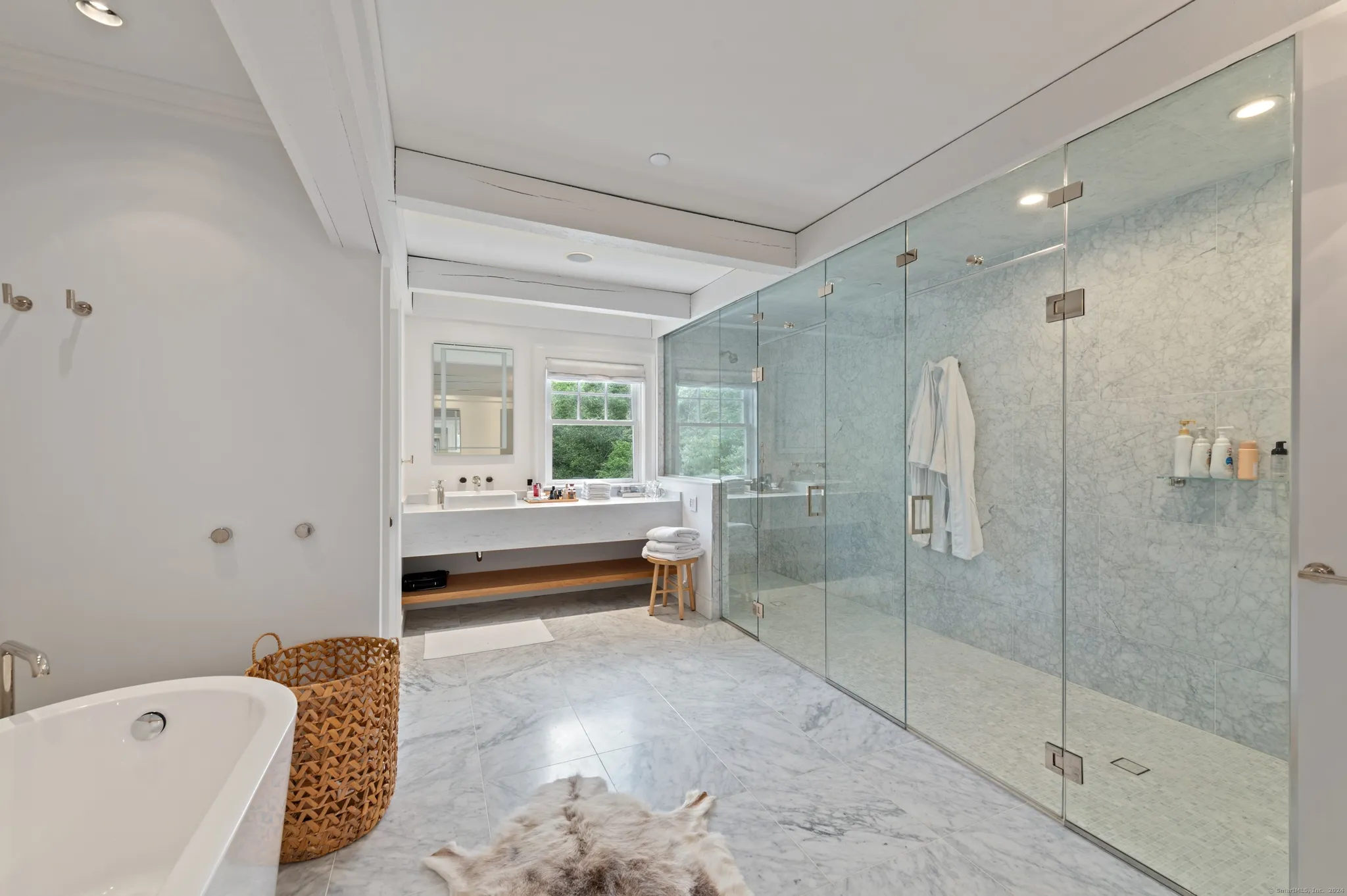 Renovated bathroom with a glass shower and freestanding bathtub